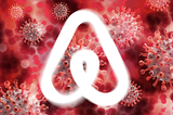 Airbnb logo in front of coronaviruses