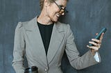Woman in Gray Blazer Holding Black Tumbler