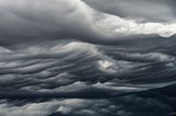 dark clouds moving in waves