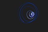 A blue light forms circles against a black background.