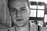A black-and-white image of the author in his mid-twenties, with Brylcreemed hair, donning 60s clothing inspired by the TV series Mad Men.
