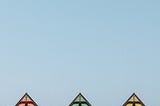 A simple picture of three cropped rooftops next to each other, very close together. Like painted ladies in San Francisco.
