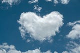 Cloud shaped like a heart with blue sky behind
