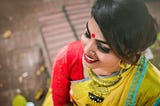 woman in yellow sari smiling