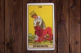 The Strength Card from the Original Rider Waite Tarot the description is given in the main text.
