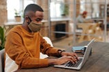 Man with laptop and facemask
