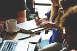 People at a desk writing