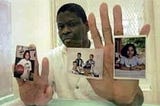 Rodney Reed behind bars with family pictures