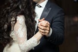 A bride and groom enjoying their first dance as a married couple.