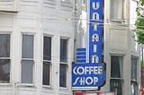 Daytime on the streets of San Francisco. Old Victorian buildings and a marquee sign for It’s Tops Fountain and Coffee Shop. Photo credit: Willis Lam, some rights reserved: https://www.flickr.com/photos/85567416@N03/28325935503/