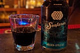 A can of beer next to a shot of Fernet