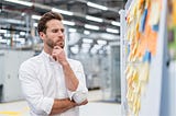 businessman thinking about switching desk booking solution