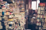 Stacks of books in a used bookstore.