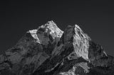 Black and white, rugged-edged mountain tops with some snow