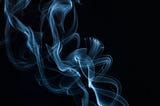 Whisps of smoke against a black background