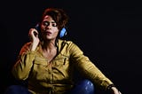 Presentation image: a woman listening to music through headphones