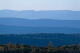 Photo of the Appalachian mountains. The mountains are layered and appear in different shades of blue from the foreground to the background.