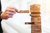 A person fixing a wooden puzzle