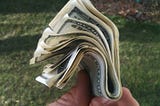 A wad of $100 bills held by the author.