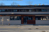 The front of Food Link’s new building, The Hub, with blue skies in the background.