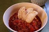 Beautiful Hot bowl of vegan chili with tortilla chips.