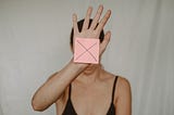 A lady showing a postit marked X
