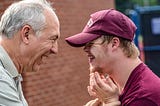 Man with son who has down syndrome, smiling