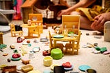 A jumble of toy kitchen items strewn on a carpet.