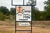 This is a picture of the Camp of the Hills sign on the raod leading into camp.