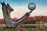 Crystal ball balancing on branch