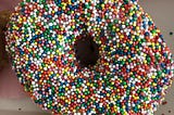 A donut covered in “hundreds-and-thousands” sprinkles