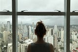 Woman standing near glass window