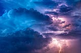 You can see clouds and lightning. It’s a beautiful A thunderstorm. The clouds are thinted in blue, purple and pink colors.