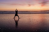 Sunset on the beach. Doing a Yoga and meditation pose