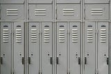 Image shows a close up view of eight stereotypical school lockers