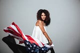 Sexy Black woman twirling the American flag