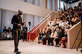 Jaylen Brown speaks to a full auditorium