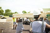 An image of people building a zero-carbon house using the WikiHouse system