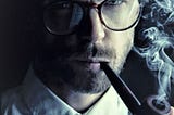 A photo of a bearded man with glasses, and smoking a piple. posing as a Sherlock Holmes type.