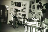 black and white photo of a cluttered art studio