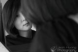 Woman having an honest conversation with herself in front of a mirror. Black and White photograph. Copyright Jean Huang Photography.
