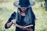 Young witch reading a book