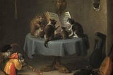 Cats sitting on a table in front of an open book of music. A cat in a colorful costume playing a baroque oboe or some such instrument. Cats, cats, cats.