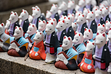 Image of fox shaped statues at a shrine in J