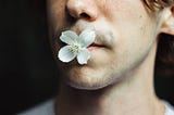 Man with a flower in his mouth