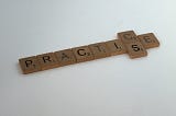 Scrabble tiles form the word practice