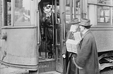 Streetcar riders required to wear masks during flu epidemic in Seattle, 1918.