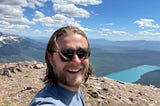 A photograph of Seth. The background is a mountain landscape with a river running through.