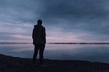 Man standing alone on a shore
