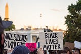 Protesters holding a “Black Lives Matter” sign